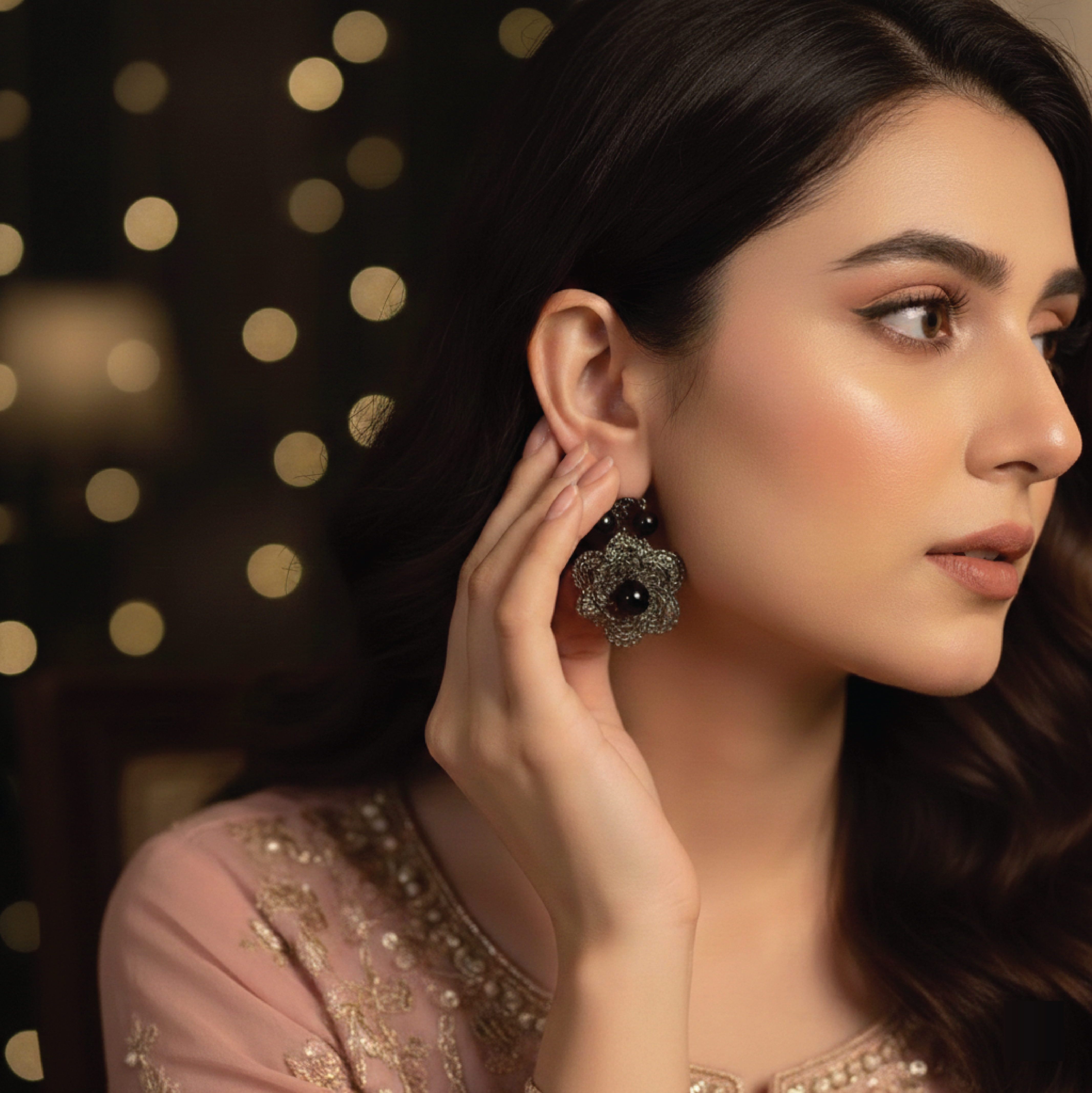 Close-up of Dewdrop earrings styled for an occasion